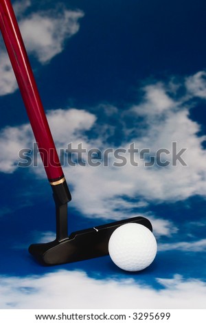 iron and golf ball on blue sky background