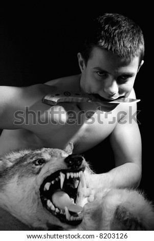 man with wolf and knife. Black and white portrait.