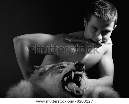 Man with wolf and knife. Black and white portrait.