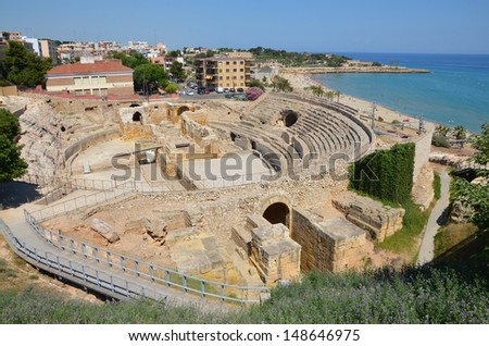 The ruins of the Roman Amphitheatre of Tarragona on modern city background