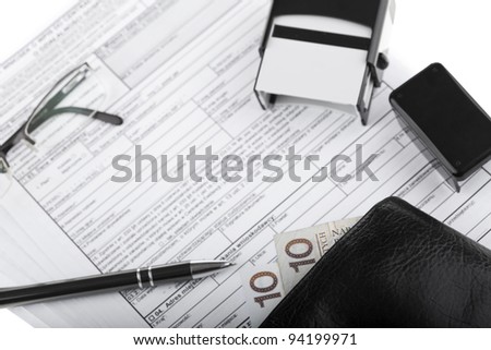 Business documents, wallet with polish paper money, pen, stamp and eyeglasses. Money and savings concept on white background.