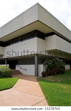 Modern building with sidewalk leading up to small staircase