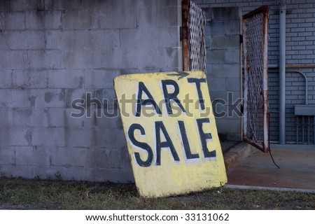 Beat Up Art Sale Sign Board Centered in image Leaning Against Block Wall Sign showing full gate