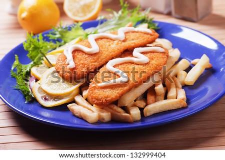Breaded fish fillet wit french fries and mayonnaise