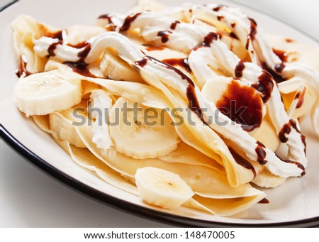 Crepes with banana fruit and chocolate topping