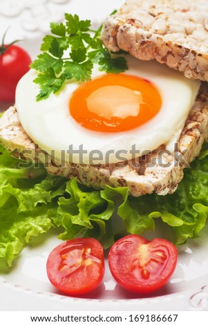 Fried egg sandwich with lettuce and rice bread