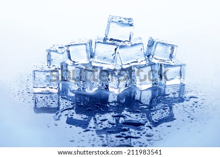 Melting ice cubes with water droplets on clear background