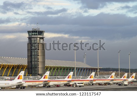 Madrid, Spain - December 16: View Of One Of The Airport Control Towers Of Madrid Barajas, And A Group Of Iberia Planes Parked In Madrid On December 16, 2012. Iberia Is The Largest Spanish Airline.