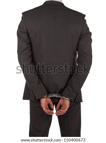 Businessman in suit and handcuffs viewed from behind isolated on white
