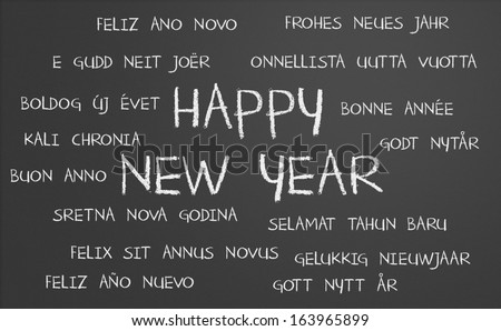 Happy new year in many different languages written on a chalkboard