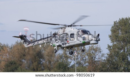 LEEUWARDEN,FRIESLAND,HOLLAND-SEPTEMBER 17: Royal Navy Helicopter Display Team \'Black Cats\' flying at the Luchtmachtdagen Airshow on September 17, 2011 at Leeuwarden Airfield,Friesland,Holland