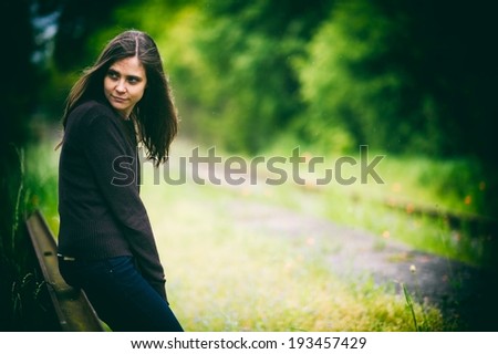 Girl waiting on a train in a rain