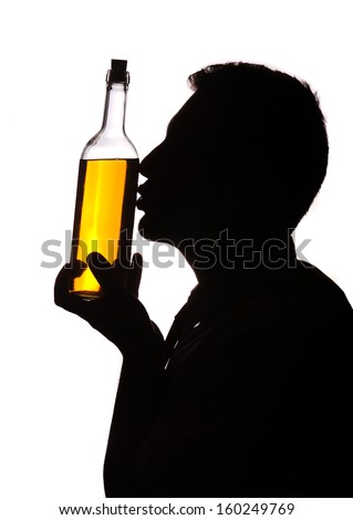 Man of silhouette giving kiss for a bottle of wine