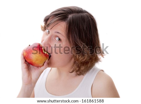 Young attractive woman is biting red apple, isolated over white