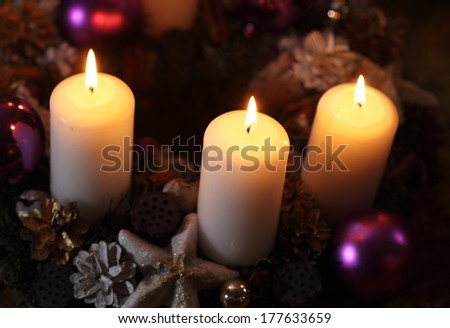 Three candles with christmas decoration