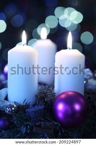 Three candles against abstract background