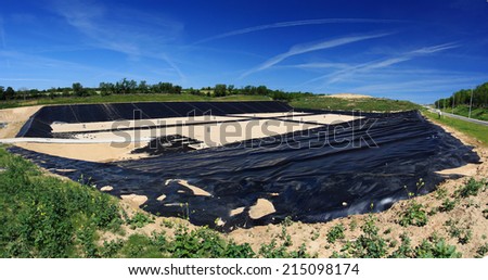 Empty new landfill with plastic isolating layer