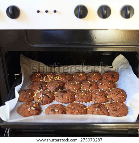 Open oven with tray of browny cakes