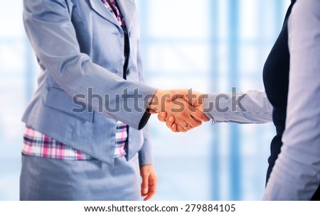 Two women give handshake after agreement