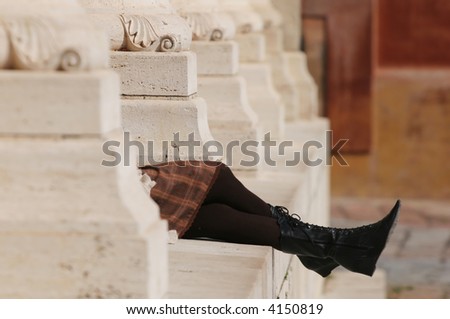 Girl\'s relaxing in brown tights between columns