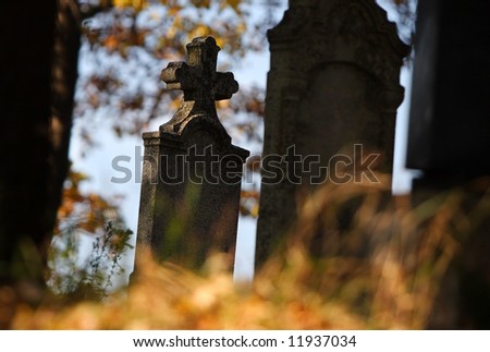 Stone tomb with cross in the cemetery