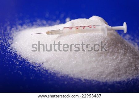 Insulin injection white a pile of sugar