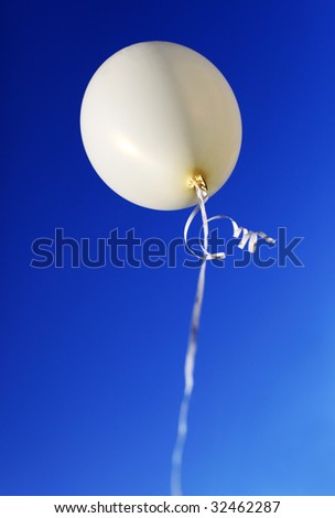 White balloon against blue sky