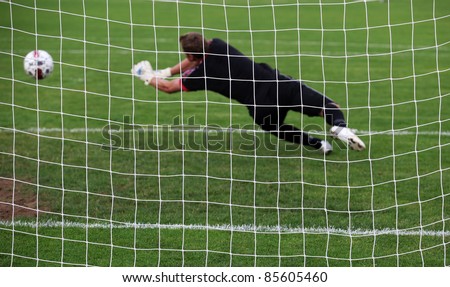 Soccer football goalkeeper making diving save