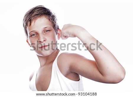 Portrait of little european boy flexing biceps. Isolated on white background