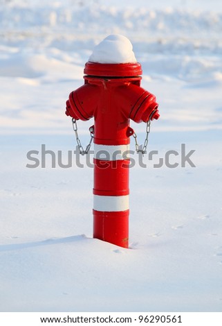 Red fire hydrant in snow in winter