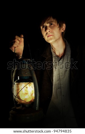Man in the dark witn lantern in his hand