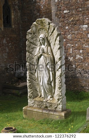Statue memorial of Saint Mary outside Saint Richard\'s Church. Duncton. West Sussex. England