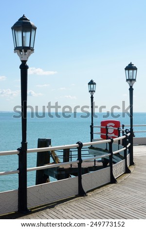 Pier and sea at Worthing, West Sussex, England. With lamps and railings