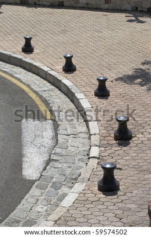 Edge of road on bend with bollards in Cannes Old Town. Cote d\'Azur. France