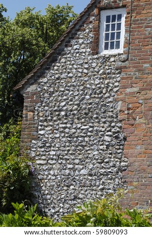 Flint-stone and brick wall to old house in Worthing. West Sussex. England