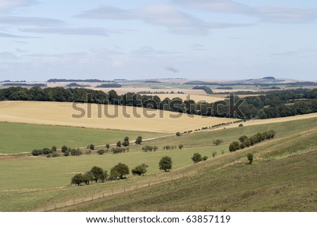 Rolling countryside with mixed agriculture near Avebury. Wiltshire. England. With heat haze and shimmer.