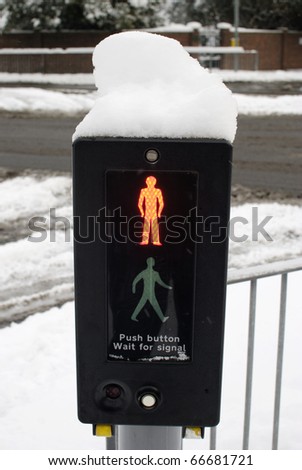 Pedestrian traffic light (Signal) with snow on. England. Signal at red