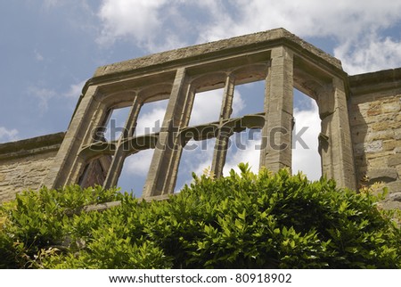 Old ruined English mansion house window frames open to the elements