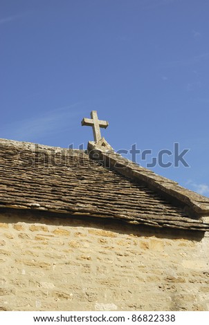 All Saints church at Great Chalfield. Near Melksham. Wiltshire. England. Close up of cross on roof.