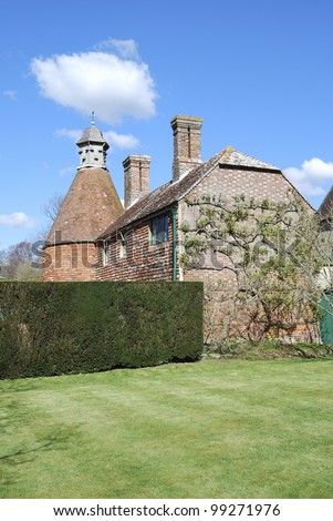 Old English house in brick and tile with attached dovecote. Sussex. England