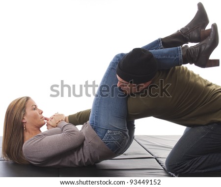 Woman overpowering a mugger using a Jiu-Jitsu arm bar