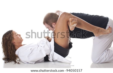 Female martial artist tapping out an opponent in a triangle choke from the guard