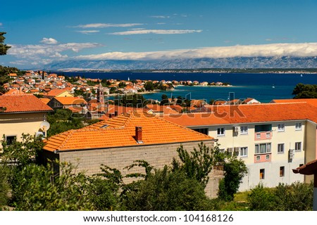 Beautiful landscape with orange houses, turquoise sea and blue sky, Croatia