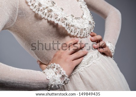 Detail of white knitted dress