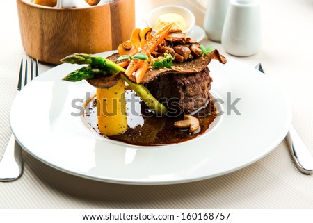 Veal steak with boletus, vegetables, duck liver and red wine sauce
