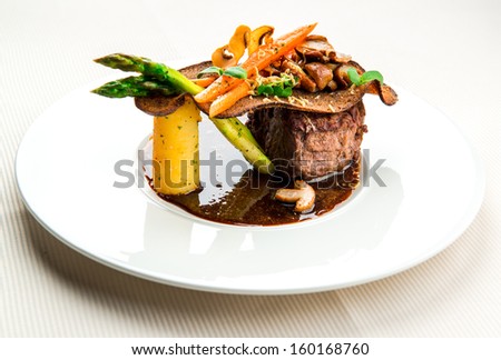 Veal steak with boletus, vegetables, duck liver and red wine sauce