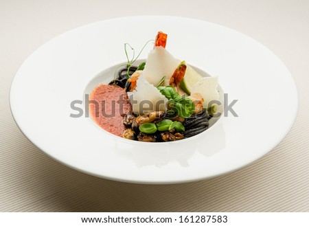 Black spaghetti with seafood, parmesan and tomato sauce