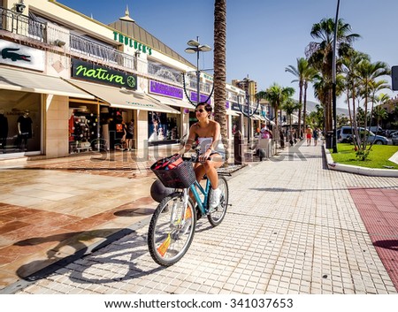 Tenerife, Spain-December 22, 2014: People walking along the Las Americas street. Las Americas is one of the most popular and well-known resorts with plenty of restaurants and shopping stores