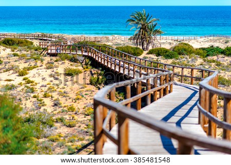 Wooden boardwalk on the Los Arenales del Sol beach. Alicante province, Costa Blanca. Spain