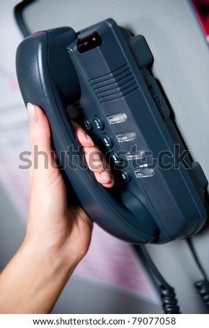 Woman\'s hand holding telephone receiver